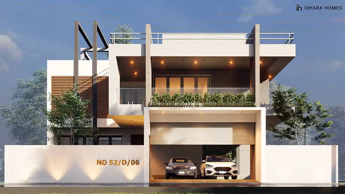 The Dreamwoods in Kadawatha at blue hour, its rooftop terrace railing and warmly lit balconies glowing above a double garage sheltering two cars.